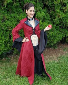 a woman in a red dress holding an apple