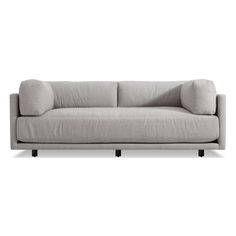 a gray couch sitting on top of a white floor