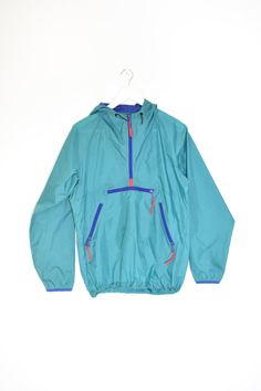 "90s VINTAGE hooded pullover windbreaker jacket    + the perfect 90s style & fit  + pull over | half zip  + kangaroo pocket for phone + necessities  + double front zip pockets  + adjustable elastic waist pull  + comfortable lightweight fabric!  brand. sierra designs  size tag marked: small  best modern women's fits: loose xs-s | fitted m  measurements:  (item lying flat, seam to seam) armpit to armpit: 22.5\" sleeve: 23\" length top to bottom: 27\" material: 100% nylon   condition: pre-owned vintage, rip + tear free, shows a few minor discoloration spots. biggest one on left side front by armpit. still wears well!   questions about it?  please message additional questions prior to purchase. please compare with measurements provided to ensure desired fit. we cannot offer exchanges or return Cheap Cotton Windbreaker With Pockets, Cheap Nylon Windbreaker With Pockets, Cheap Nylon Windbreaker For Streetwear, Cheap Long Sleeve Windbreaker With Pockets, Cheap Functional Nylon Windbreaker, Cheap Trendy Windbreaker With Pockets, Affordable Windbreaker With Adjustable Hood, Affordable Functional Windbreaker With Pockets, Affordable Long Sleeve Windbreaker With Pockets