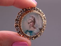 Jewelry Type: Brooch Pin (can be worn as pendant) Metal: 14k Yellow Gold Measurements: 1 1/4 inch x 1 1/4 inch wide ( front face of pin) Markings: 14k Weight: 8.3 grams Main Stone: Painted Portrait Measurement: 20mm #3670 Victorian Gold Brooch With Locket, Victorian Gold Locket Brooches, Elegant Medallion Brooch For Collectors, Ornate Gold Locket Brooches, Antique Gold Victorian Brooch Jewelry, Victorian Gold Pendant Brooches, Victorian Gold Brooch Jewelry, Victorian Brooches With Locket Pendant, Victorian Yellow Gold Collectible Brooch