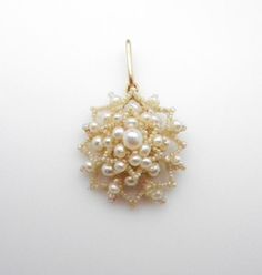 Delicate Vintage 14k Yellow Gold Pearl Pendant Measures approximately 1.5" tall X 1" Wide No missing pearlsGood vintage condition - there is some loose thread on the back but the pearls are secured (see pictures 2 & 6) Total weight: 2.7 Grams Gold Chain not included, for picture purposes onlyNeed a Gold or Sterling Silver Chain?https://www.etsy.com/shop/WatchandWares?ref=seller-platform-mcnav§ion_id=24412209Back to all Pendants and Charms:https://www.etsy.com/shop/WatchandWares?ref=seller-pl Elegant Beaded Flower-shaped Jewelry, Formal Flower-shaped Pearl Drop Jewelry, Yellow Gold Flower Jewelry With Pearl Drop, Flower-shaped Pearl Pendant Jewelry For Wedding, Flower-shaped Pearl Drop Jewelry For Anniversary, Flower Shaped Pearl Drop Jewelry For Anniversary, Floral Pearl Pendant Jewelry For Weddings, Yellow Gold Beaded Jewelry For Wedding, Yellow Gold Beaded Wedding Jewelry