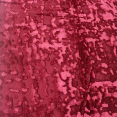 a close up view of a red rug with lots of small dots on the surface