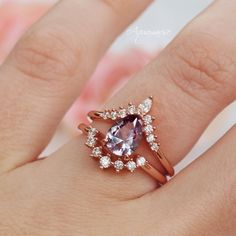 Gorgeous Alexandrite Ring Set ►Base Metal: Sterling Silver (925) ►Plating: 14K Rose Gold Vermeil ►Accented With Simulated Diamonds (CZ) ►Free wedding band is included Center Stone: Alexandrite Color: Purple/Pink/Blue Stone cut: Teardrop Gem size: 9.0x 6.0 mm Average Carat Weight: 1.5 ct. Gemstone creation: 100% Genuine Lab-Grown Alexandrite Stone Origin: Russia Hardness: 8.5 (Mohs scale) ►The color of Alexandrite changes under different lighting conditions. If viewed in daylight, its color is pu Rose Gold Sapphire Ring For Wedding With Round Band, Rose Gold Sapphire Ring With Round Band For Wedding, Rose Gold Sapphire Wedding Ring With Round Band, Heirloom 14k Rose Gold Promise Ring, Classic 14k Rose Gold Rings With Accent Stones, Rose Gold Amethyst Ring For Wedding, Dainty Rose Gold Amethyst Wedding Ring, 14k Rose Gold Rose Cut Diamond Promise Rings, 14k Rose Gold Sapphire Ring For Wedding