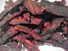 a pile of red food sitting on top of a white plate