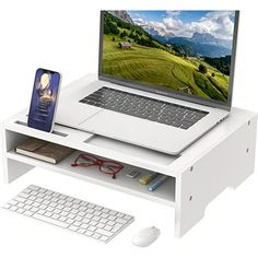 an open laptop computer sitting on top of a white desk