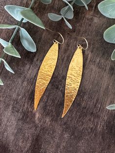 "Inspired from the olive leaves, for the strength that they show throughout the seasons and their delicate shape, offering their natural beauty effortlessly.  Olive leaves have been used as a symbol of win, overcoming obstacles and new beginnings for centuries. These beautiful leaf earrings are hand forged and hammered to shimmer and sparkle!  Keep the eyes on you with these minimal yet statement earrings! Totally lightweight perfect for everyday wear. Wear them with your dress or with your jean Nature-inspired Hammered Earrings As Gift, Leaf-shaped Brass Earrings With Ear Wire, Leaf-shaped Brass Earrings As Gift, Leaf-shaped Brass Earrings For Gift, Pebble Pendant, Cube Necklace, Gold Leaf Earrings, Hammered Earrings, Gold Dangle Earrings