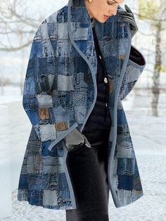 a woman walking in the snow wearing a blue coat