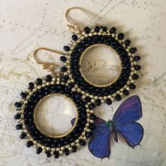 Stunningly beautiful seed bead hoop earrings made with black 8/0 and gold metallic 11.0 seed beads. The french hook earwires and findings are are 14kt gold plated. These very lightweight earrings are handmade by me with each tiny bead individually woven. They measure 2 inches total including the earwires. The hoops are 1.5 inches. These earrings go perfectly with all outfits and occasions. Wear these stunning earrings and get ready for compliments Thanks for looking and please stop by again. Gold Small Hoop Earrings With Spacer Beads, Small Black Hoop Earrings For Jewelry Making, Gold Hoop Earrings With Spacer Beads, Gold Small Hoop Earrings With Tiny Beads, Black Beaded Small Hoop Earrings As Gift, Bohemian Black Hoop Earrings With Dangling Beads, Gold Beaded Circle Earrings, Elegant Black Beaded Earrings With Tiny Beads, Elegant Black Earrings With Tiny Beads