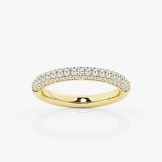 a yellow gold wedding band with rows of diamonds on the top and bottom, set against a white background