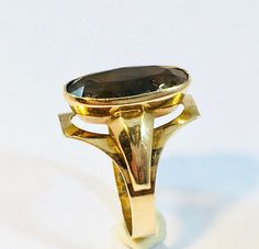 Vintage Gold Ring with faceted Smoky Quartz, by Oiva Laaksonen, Turku Finland 1966. ( Oiva Laaksonen was registered Goldsmith in Turku from 1962-1982 ) The top part of the ring is 18mm x 13mm, with a faceted Smoky Quartz in the centre. The Smoky Quartz is 17mm x 9mm. The ring size is 17.3 (inner diameter) according to the size charts is this US size 7 and Europe size 54 Hallmarks: Symbol Designer Mark for Oiva Laaksonen  Crown in Heart / Finland National Mark 585 / Gold Purity Mark 14k Turku Cit Brown Hallmarked Vintage Ring, Fine Jewelry 14k Gold Brown Ring, Fine Jewelry In 14k Gold, Brown, Luxury Gold-tone Brass Rings, Modernist Hallmarked Yellow Gold Jewelry, Turku Finland, Vintage Gold Rings, Smoky Quartz, Finland