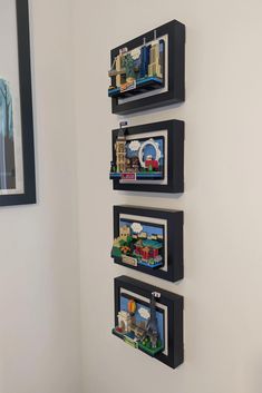 three black shelves with legos on them in a corner next to a white wall