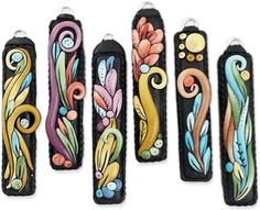 four different types of leather cases with designs on the sides and one is painted in multicolor