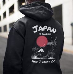 Introducing the "Spirit of Japan" Hooded Sweatshirt Collection, a captivating fusion of iconic Japanese symbols and contemporary fashion. This unique hoodie embodies Japan's cultural beauty, showcasing Mount Fuji, the Rising Sun, and the famous Japanese wave, all masterfully printed on the back to create a cool and eye-catching design. Our passion for Japanese culture shines through this wearable work of art, perfect for any Japan enthusiast. Available in six versatile colors - bold black, class Winter Fan Merchandise Crew Neck Hoodie, Black Hoodie With Front And Back Print, Urban Hoodie With Front And Back Print For Winter, Winter Hoodie With Front And Back Print, Winter Hoodie Sweatshirt With Front And Back Print, Casual Hoodie With Front And Back Print For Winter, Hooded Sweatshirt With Back Print For Winter, Winter Hooded Sweatshirt With Back Print, Hooded Winter Sweatshirt With Back Print