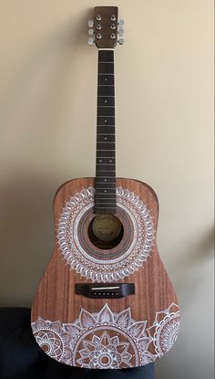 a wooden guitar with an intricate design on it