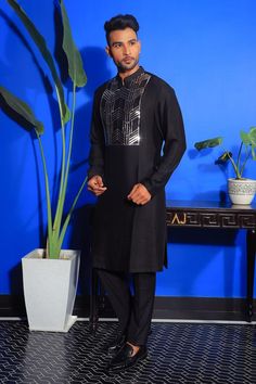 Black band collar kurta with an embroidered placket. Paired with a black trouser.
Components: 2
Pattern: Embroidered
Neckline: Band collar
Sleeve Type: Long
Fabric: Silk, Stretch Cotton
Color: Black
Occasion: Sangeet - Aza Fashions Formal Embroidered Black Kurta, Black Long Sleeve Traditional Wear With Embroidered Border, Designer Black Traditional Wear For Festivals, Black Long Sleeve Traditional Wear For Transitional Season, Traditional Long Sleeve Party Wear With Embroidered Border, Black Traditional Wear With Embroidered Border For Party, Traditional Long Sleeve Wear With Embroidery, Black Kurta For Ceremonial And Transitional Seasons, Black Traditional Kurta With Stand Collar