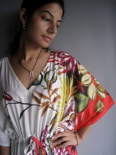 I made this Kaftan top from a beautiful light cream with red border and flowers 100% mulmul cotton.Mulmul is a very fine variety of cotton which is extremely soft and it gets softer with every wash.It is so free flowing, that it will make you feel as if you aren't wearing anything at all ;)The beauty of the Kaftans is they will fit everyone so no need to worry about the size et all. All my Kaftans have deep necks so will fit all head sizes.However, the length of my kaftans will vary. This top is Red Summer Tops For Loungewear, Red Summer Top For Loungewear, White Tops With Kimono Sleeves For Summer, White Beach Tops With Kimono Sleeves, White Kimono Sleeve Top For Beach, White Kimono Sleeve Beach Tops, Red Kaftan, Spa Robes, Kaftan Tops