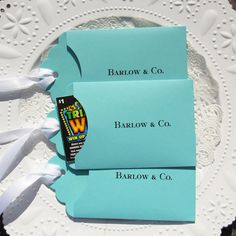 two blue envelopes sitting on top of a white doily