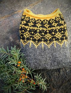 a knitted hat sitting on top of a rock