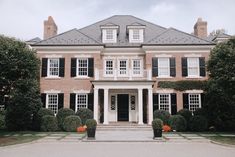 a large red brick house with black shutters