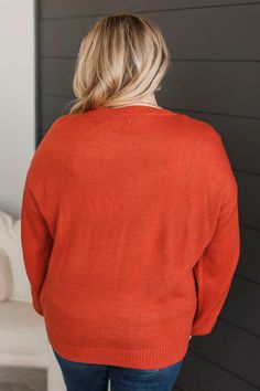 Fit & Details: Oversized, relaxed fit. If in-between sizes, you could size down. Soft knit material with an embroidered "pumpkin" detail along bust Round neckline Drop shoulder sleeves Measurements: Small: Bust 46“ Length 25“ Medium: Bust 48“ Length 26“ Large: Bust 50“ Length 27“ Fabric & Material Care: Hand wash cold. Hang or line dry. 100% Acrylic. *Imported* Model Info: Leah is modeling a large. Britta is modeling a small. Orange V-neck Knit Sweater, Solid Color Crew Neck Cardigan For Fall, Casual Orange Cotton Cardigan, Fall Cardigan With Ribbed Neckline, Orange Sweater With Relaxed Fit And Long Sleeves, Orange Relaxed Fit Long Sleeve Sweater, Fall Knit Cardigan With Ribbed Neckline, Fall Cotton Orange Sweater, Casual Cardigan With Ribbed Neckline For Fall