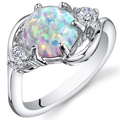 Moonlit magic It's the simple things in life. These whimsical and playful Opal colors will dance with you all day (and night). This graceful ring features a round shape Peora created Opal gemstone in .925 sterling silver. Responsibly sourced in every sense, our created Opal gemstones are physically, chemically, and optically identical to their natural counterparts. We're big fans of eco-luxury. Handcrafted in pure .925 sterling silver goodness, this ring has been carefully coated in an elegant rhodium finish. Our artisans are expertly trained in this process which fortifies the ring's strength, shine and brilliance. Main Stone Lab Created Opal 1.75 Carats, round shape, 8 x 8 mm White color with a SI1-SI2 clarity Accent Stone Cubic Zirconia Round shape, 1 x 1 mm White color with a VS1-VS2 c White Opal Ring, Ring Opal, Fire Opal Ring, Opal Stone, Opal Ring, Sea Glass Jewelry, White Opal, Vintage Bracelets, Opal Rings