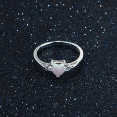 This lovely ring features a delicate opal heart encased in a sterling silver and partner on each side by dazzling gemstones. This heart perfectly symbolizes love. The opal heart measures 6 mm and the dazzling gemstones measure 1mm x 2.25 mm. Purchase the Opal Heart Necklace in our Jewelry Collection and save $6 when buying both of these together using discount code: OPALHEART$60FF at checkout. Opal Heart Ring, Opal Stone Ring, Heart Stone, Opal Engagement, Heart Shaped Rings, Lovely Ring, Opal Stone, Stone Heart, Love Ring