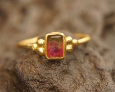 watermelon tourmaline ring, 24k gold ring, 24k gold ring, unique engagement ring, 24k gold gem ring, gold artisan engagement ring, statement ring I love watermelon tourmaline and with this delicate 24k gold setting , it's a refreshing stone breathtaking piece. stone is 6X4.5 mm  watermelon tourmaline I used 24k gold for the setting,  and 22k for the rest of the wire ring (1.4 mm) Please view my full collection of earrings:  https://www.etsy.com/geffenjewelry The jewelry will be packed in a gift Gold Tourmaline Rings, Watermelon Tourmaline Engagement Ring, Gold Ring Unique, Watermelon Tourmaline Ring, Bezel Earrings, Minimal Ring, Wire Ring, Unique Engagement Ring, Dope Jewelry