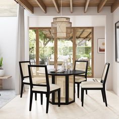 a dining table with four chairs and a chandelier hanging from it's ceiling