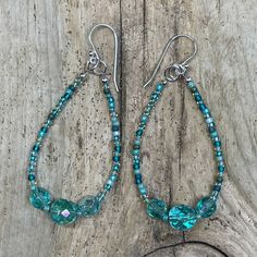 Blue green glass seed bead earrings with Czech crystals. Beautiful long dangly earrings perfect for summer! The earrings have all sterling silver findings including the ear wires.Premium Japanese glass seed beadsGenuine Czech CrystalsAbout 2 5/8" L x 1" W925 Sterling silver ear wires Crystals Beautiful, Long Dangle Earrings, Czech Crystal, Ear Rings, Dangly Earrings, Earring Patterns, Seed Bead Earrings, Aqua Green, Bead Earrings