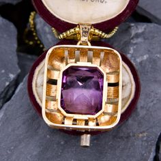 This fabulous large amethyst pendant is centered with a rectangular cut amethyst that is accented with a halo of high polished open gold work. The pendant is crafted in 14k yellow gold and is about 1.25" long. We have added an 18 inch long 14k yellow gold rounded box chain weighing approximately 3 grams. Art Deco Jewelry With Rectangular Pendant As Gift, Art Deco Jewelry With Rectangular Pendant For Gift, Luxury Rectangular Amethyst Jewelry, Elegant Purple Locket Jewelry, Antique Octagon Shaped Jewelry For Gifts, Antique Octagon Jewelry Gift, Luxury Purple Rectangular Jewelry, Purple Rectangular Jewelry For Formal Occasions, Formal Rectangular Purple Jewelry