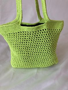 My lovely neon green/yellow tote bag is navy blue lined, knitted, lightweight and zip-free.  Easy to combine with your summer outfits. Size Width: 10cm (3.93'') Height: 30cm (4.64'') Depth: 12cm (4.72'') Handle length: 57cm (22.44'') Lightweight Summer Shopping Bags, Green Crochet Bag For Beach Shopping, Green Crochet Bag For Beach Season Shopping, Trendy Green Knitted Shoulder Bag, Casual Knitted Beach Bag, Spring Knitted Shopping Bags, Casual Knitted Shopping Bags, Casual Yellow Shoulder Beach Bag, Casual Yellow Beach Shoulder Bag