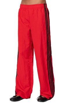 Sporty stripes trail the sides of these wide-leg nylon track pants topped with a comfortable low-rise elastic waist. Elastic waist 100% nylon Machine wash, dry flat Imported Nylon Track Pants, Fall Wardrobe Essentials, Romantic Dress, Sports Blazer, Kids Sweater, Denim Jumpsuit, Pant Shirt, Swimsuit Cover, Toddler Girl Outfits