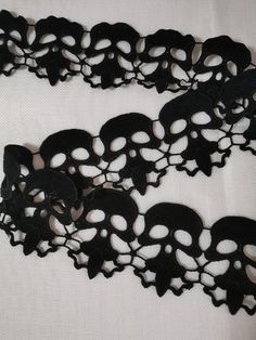 two pieces of black lace with skulls on them