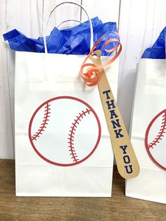 two paper bags with baseballs on them and the words thank you written on them
