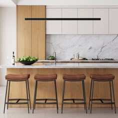 three stools sit in front of an island with marble countertops and wooden cabinets