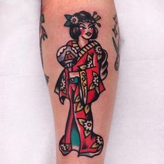 a woman with a geisha tattoo on her leg