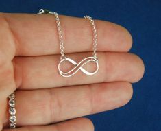 Sterling silver double infinity necklace, infinity knot, infinity symbol, bridal jewelry, sterling silver necklace, eternity necklace A double wire infinity link is attached to a sterling silver chain that can be any length up to 22 inches in length and is secured with a sterling silver lobster claw clasp. You can choose between the small, medium, and large infinity links. The small infinity measures 0.55 x 0.26 inches (14 x 6.5mm). The medium infinity measures 0.79 x 0.37 inches (20 x 9.5mm). T Silver Infinity Necklace In Dainty Style, Silver Infinity Dainty Necklace, Silver Dainty Infinity Necklace, Dainty Silver Infinity Necklace, Silver Infinity Jewelry, Sterling Silver Infinity Necklace With Adjustable Chain, Silver Infinity Necklace With Delicate Chain, Dainty Infinity Silver Jewelry, Dainty Silver Infinity Jewelry