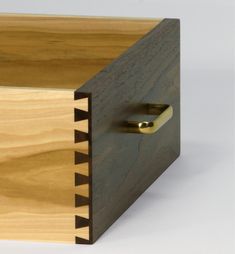 a close up of a wooden box with metal handles and wood grained finish on it