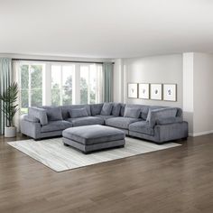 a living room filled with furniture on top of a hard wood floor