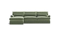 a green couch sitting on top of a white floor