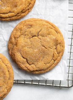 three cookies sitting on top of a cooling rack