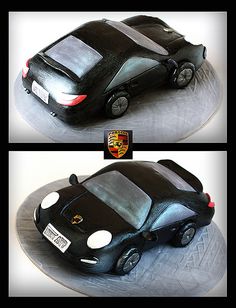 a cake shaped like a car on top of a silver plate with black icing