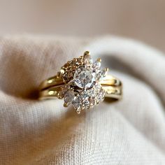 a diamond ring sitting on top of a white cloth