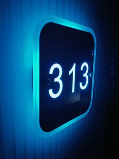 a blue illuminated sign with the number 3813 on it