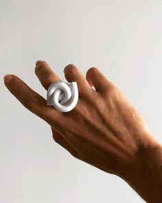 "The Cloud Knot Ring is a collection of contemporary acrylic design inspired by its symbolism of love, connection and binding. It also symbolizes peace, unity, protection and liberation. I made this ring while listening to the song \"I want to break free\" from the album The Works by Queen. The song is a symbolism of the fight against oppression and women's liberation movement. Each piece is unique allowing for collectors to style themselves with contemporary wearable design. 100% Acrylic | Hand Modern White Open Ring, White Modern Twist Ring Jewelry, Modern Adjustable White Rings, Modern White Adjustable Rings, Modern White Adjustable Ring, Modern White Jewelry, Modern White Rings For Gifts, Modern Twist White Rings As Gift, White Rings With A Modern Twist As A Gift