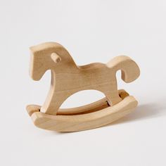 a wooden rocking horse toy on a white background