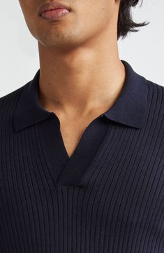 The renowned British label has elevated the wardrobe-staple polo with this rib-knit version crafted for softness from a blend of silk and cotton. 26 1/2" length (size Medium) Button half placket Spread collar Short sleeves 55% silk, 45% cotton Dry clean or hand wash, dry flat Made in Portugal Designer Clothing Classic Ribbed Merino Wool Top, Fitted Navy Polo Sweater With Ribbed Collar, Classic Merino Wool Top With Ribbed Neckline, Classic Merino Wool Tops With Ribbed Neckline, Fitted Knit Polo Sweater With Polo Collar, Classic V-neck Polo Shirt With Ribbed Collar, Knit Polo Sweater With Seamless Collar, Navy Fitted Collared Polo Sweater, Fitted Navy Collared Polo Sweater