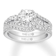 a white gold ring with diamonds and the words the lie on it's side