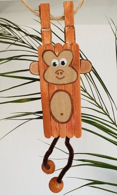 a wooden monkey ornament hanging from a rope