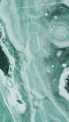 an aerial view of water and land from above, looking down at the ocean surface